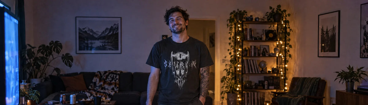 Man in a living room at night wearing the Cruel Royalty Dark Lord Sauron graphic tee, torn gift wrap on the floor