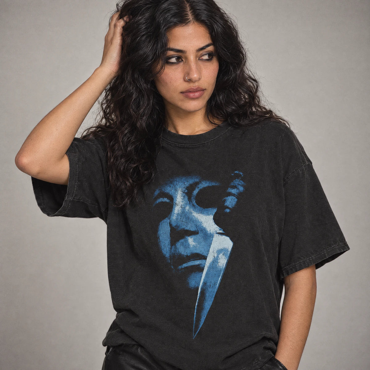 Model wearing Cold Blade Tee, masked boogeyman horror shirt in black Comfort Colors cotton