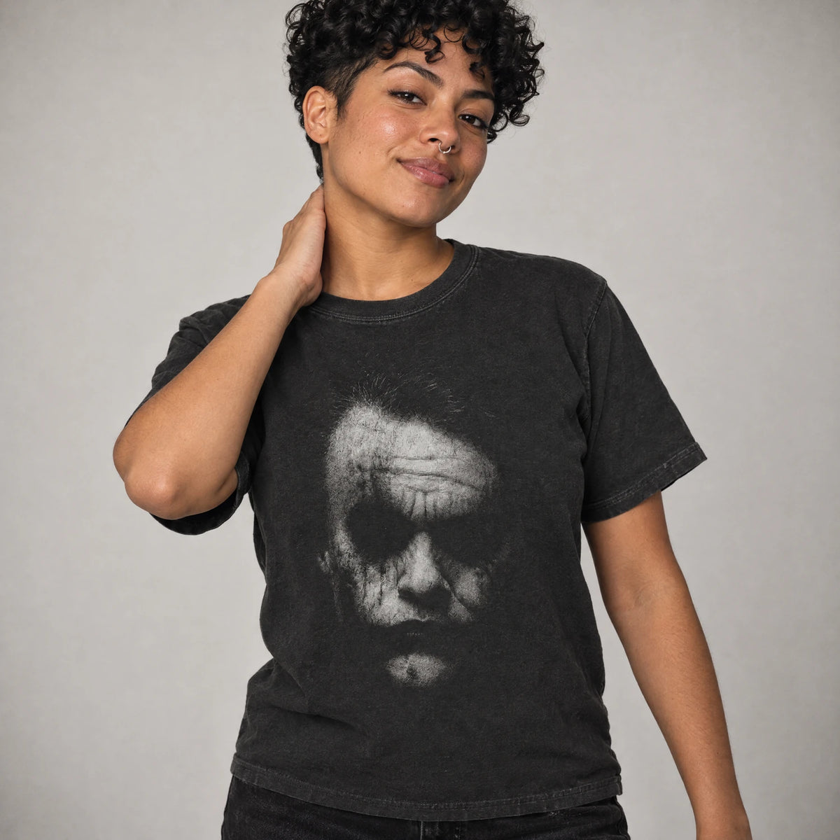 Model wearing Smeared Face Tee, anarchist clown villain shirt in black Comfort Colors cotton